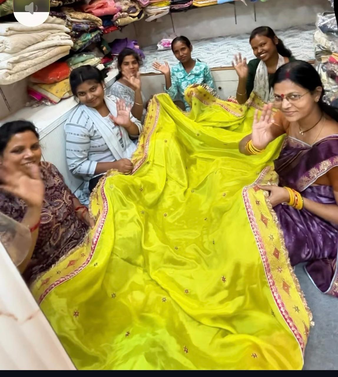 lifestyle shot of kids running in a wildflower meadow wearing artisanal linen clothes